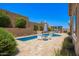 A backyard featuring a private pool, a pergola, and lush plants at 27562 N 99Th Dr, Peoria, AZ 85383
