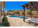Relax in the sun, or lounge under the pergola in this backyard featuring a private pool at 27562 N 99Th Dr, Peoria, AZ 85383