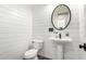 Charming powder room with shiplap walls and a pedestal sink at 27562 N 99Th Dr, Peoria, AZ 85383