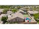 Aerial view of a property showcasing a pool, putting green, well-maintained landscaping, and desert surroundings at 29816 N 51St Pl, Cave Creek, AZ 85331