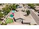 Aerial view showcasing a home with a putting green, a private pool, lush landscaping, and a charming patio area at 29816 N 51St Pl, Cave Creek, AZ 85331