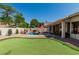Backyard featuring pool, putting green, covered patio, and privacy landscaping at 29816 N 51St Pl, Cave Creek, AZ 85331