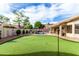 This backyard features a putting green and a beautiful pool area perfect for entertaining at 29816 N 51St Pl, Cave Creek, AZ 85331