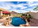 Backyard featuring a private pool, putting green, and rock waterfall with lush desert landscaping at 29816 N 51St Pl, Cave Creek, AZ 85331