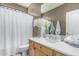 Bathroom featuring a wooden vanity, framed mirror, and shower-tub with a white curtain at 29816 N 51St Pl, Cave Creek, AZ 85331