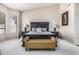 Well-lit bedroom featuring a large, ornate bed with decorative pillows and matching bedside tables and lamps at 29816 N 51St Pl, Cave Creek, AZ 85331