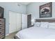 Comfortable bedroom with neutral walls, a cozy bed, wardrobe, and decorative Buffalo art piece at 29816 N 51St Pl, Cave Creek, AZ 85331