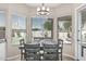 Dining area featuring large windows, backyard view, and contemporary light fixture at 29816 N 51St Pl, Cave Creek, AZ 85331