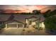 Inviting front exterior featuring a well-manicured yard and a convenient three-car garage with a sunset at 29816 N 51St Pl, Cave Creek, AZ 85331