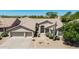 Charming home features a well-manicured desert front yard with a large, attached two-car garage at 29816 N 51St Pl, Cave Creek, AZ 85331