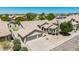 Exterior shot of a well-maintained home, featuring a three-car garage, desert landscaping, and a private putting green at 29816 N 51St Pl, Cave Creek, AZ 85331