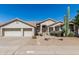 Home featuring a two-car garage and desert landscaping including cactus, bushes, and desert plants at 29816 N 51St Pl, Cave Creek, AZ 85331