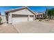 Spacious three-car garage with a wide driveway and desert landscaping enhancing the curb appeal at 29816 N 51St Pl, Cave Creek, AZ 85331