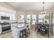 Kitchen with stainless steel appliances, white cabinets, granite countertops, and breakfast bar seating at 29816 N 51St Pl, Cave Creek, AZ 85331