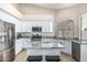 Contemporary kitchen with stainless appliances, granite counters, breakfast bar, and white cabinets at 29816 N 51St Pl, Cave Creek, AZ 85331