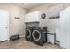Functional laundry room featuring a washer, dryer, storage cabinets, and neutral tile flooring at 29816 N 51St Pl, Cave Creek, AZ 85331