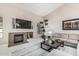 Bright living room showcasing a fireplace, neutral decor, large TV, and tall ceilings at 29816 N 51St Pl, Cave Creek, AZ 85331