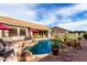 Resort style pool with rock waterfall features surrounded by beautiful desert landscape in backyard at 29816 N 51St Pl, Cave Creek, AZ 85331