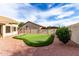 Backyard putting green is surrounded by desert landscaping and features mature trees and a putting green at 29816 N 51St Pl, Cave Creek, AZ 85331