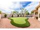 Backyard putting green with synthetic turf and surrounding desert landscaping, perfect for practicing your short game at 29816 N 51St Pl, Cave Creek, AZ 85331
