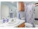 Well-lit bathroom with a toilet, shower/tub combo, and vanity with a large mirror and updated fixtures at 3018 W Country Club Ter, Phoenix, AZ 85027