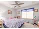 Cozy bedroom with a colorful quilt, window with blinds, carpet, and a ceiling fan for comfort at 3018 W Country Club Ter, Phoenix, AZ 85027
