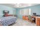 Comfortable bedroom with light blue walls, tiled floors, a ceiling fan, and a large window with blinds at 3018 W Country Club Ter, Phoenix, AZ 85027