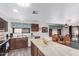 Open kitchen featuring wood cabinets, marble countertops, and an adjacent dining area with lots of natural light at 3018 W Country Club Ter, Phoenix, AZ 85027