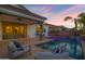 Beautiful backyard and pool area with a water feature lit with colorful lights at 3038 E Longhorn Dr, Gilbert, AZ 85297