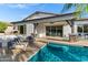 Backyard featuring a pool, outdoor kitchen, and comfortable seating area at 3038 E Longhorn Dr, Gilbert, AZ 85297