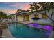 Backyard featuring a patio, pizza oven, pool and lounge chairs, a perfect outdoor oasis at 3038 E Longhorn Dr, Gilbert, AZ 85297