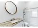Bathroom featuring a marble countertop, framed mirror, sink and enclosed shower at 3038 E Longhorn Dr, Gilbert, AZ 85297