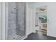 Bathroom with marble shower featuring seamless glass door, built in shelving, and chrome fixtures at 3038 E Longhorn Dr, Gilbert, AZ 85297