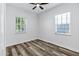 Bright bedroom features wood-look floors, and natural light from the two windows at 3038 E Longhorn Dr, Gilbert, AZ 85297