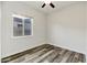 Clean and simple bedroom with light wood floors, bright light, and neutral paint at 3038 E Longhorn Dr, Gilbert, AZ 85297