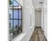 Bright hallway with wood floors and multiple windows leading to an outdoor patio at 3038 E Longhorn Dr, Gilbert, AZ 85297