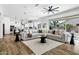Bright living room featuring an open layout with access to the kitchen and backyard views at 3038 E Longhorn Dr, Gilbert, AZ 85297