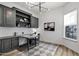 Well-appointed home office with custom cabinetry, built-in shelving, and a modern chandelier at 3038 E Longhorn Dr, Gilbert, AZ 85297