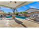 Backyard featuring a stunning pool with stone pillars under a covered patio at 3038 E Longhorn Dr, Gilbert, AZ 85297