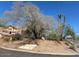 The Carefree Foothills entrance features desert landscaping, and a tranquil ambiance, creating a welcoming atmosphere for residents and guests at 34611 N Sunset Trl, Cave Creek, AZ 85331