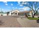 Charming home boasts desert landscaping, paver driveway, and a three-car garage at 34611 N Sunset Trl, Cave Creek, AZ 85331