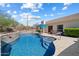 Backyard pool area with a raised wall water feature, blue water, lounge chairs, and desert views at 34611 N Sunset Trl, Cave Creek, AZ 85331