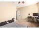 Comfortable bedroom with neutral walls, plush carpeting, and a ceiling fan for added comfort at 36179 W Cartegna Ln, Maricopa, AZ 85138