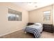 A bright bedroom with large window is perfect for sleep, study, or relaxation at 36179 W Cartegna Ln, Maricopa, AZ 85138