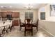 An elegant dining area with wood table and chairs offers a cozy place to dine at 36179 W Cartegna Ln, Maricopa, AZ 85138