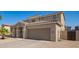Home exterior showcasing desert landscaping and a spacious two-car garage at 36179 W Cartegna Ln, Maricopa, AZ 85138
