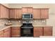 Kitchen showcases granite countertops, stainless steel appliances, and ample cabinet space at 36179 W Cartegna Ln, Maricopa, AZ 85138