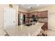 Spacious kitchen featuring granite countertops, stainless appliances, and barstool seating at 36179 W Cartegna Ln, Maricopa, AZ 85138