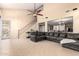 This spacious living room features tile floors, a ceiling fan, and easy access to the kitchen at 36179 W Cartegna Ln, Maricopa, AZ 85138