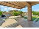 Lush backyard oasis with a covered patio, a pool, desert landscaping, and an outdoor kitchen area at 3817 E Patrick Ln, Phoenix, AZ 85050